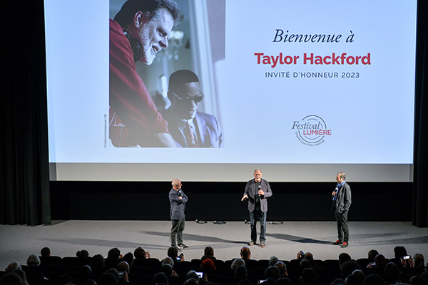 <span style='display:inline-block; background-color:#DF071E; width: 100%;padding:5px;'>Taylor Hackford</span>